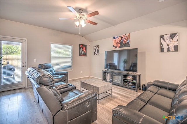 living room with lofted ceiling, ceiling fan, and light wood-type flooring