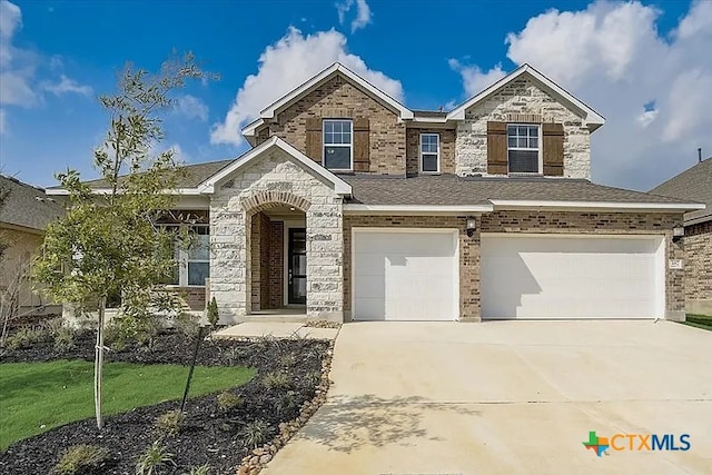 view of front facade with concrete driveway, brick siding, a front lawn, and an attached garage