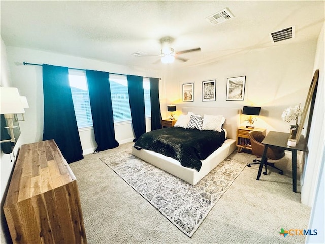 bedroom with baseboards, carpet, visible vents, and a ceiling fan