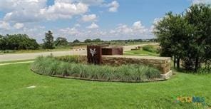 view of home's community featuring a lawn