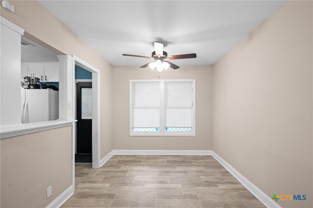 empty room with baseboards and ceiling fan