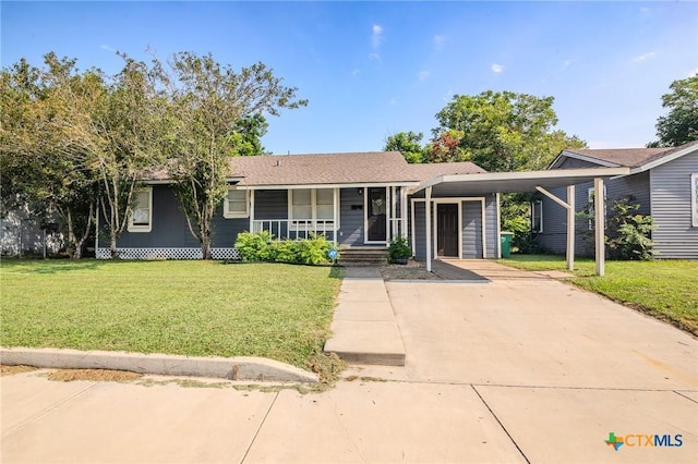 ranch-style house with concrete driveway, a carport, a front yard, and covered porch