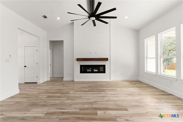 6 E Pima Ln, Belton, TX 76513 - unfurnished living room featuring vaulted ceiling, a ceiling fan, a large fireplace, light wood-style floors, and baseboards