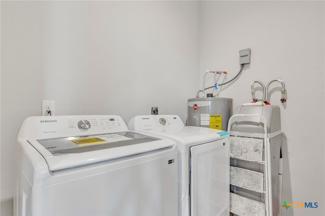 clothes washing area with water heater and washer and dryer