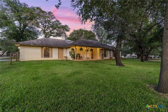1843 Burr Oak Ln, Adkins, TX 78101 - back of house at dusk with a yard and brick siding
