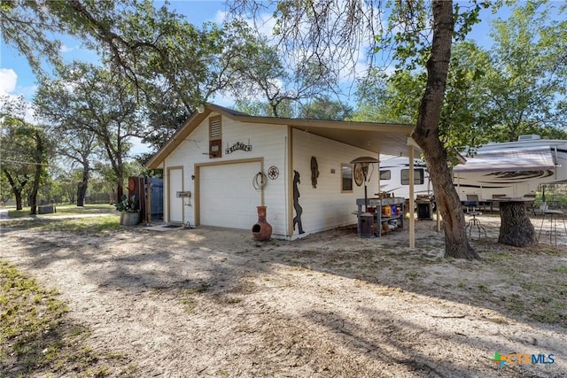 1843 Burr Oak Ln, Adkins, TX 78101 - view of home's exterior with an outbuilding and a detached garage