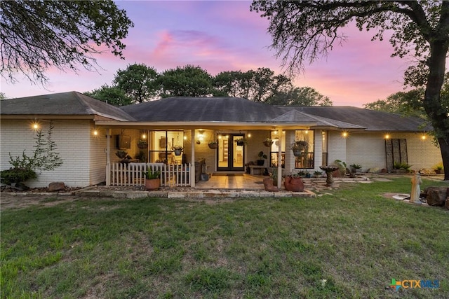 1843 Burr Oak Ln, Adkins, TX 78101 - rear view of property featuring brick siding, a yard, and french doors