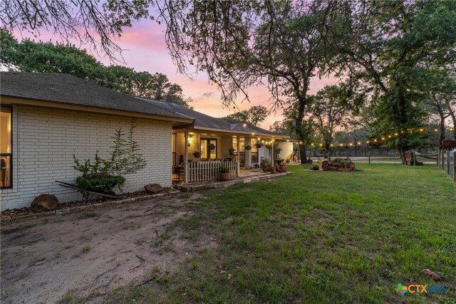 1843 Burr Oak Ln, Adkins, TX 78101 - yard at dusk with covered porch