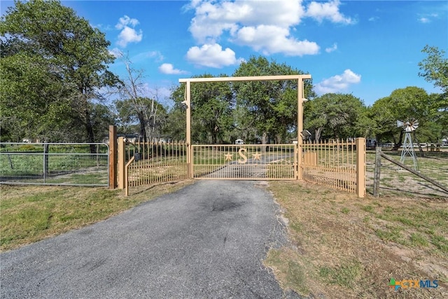 1843 Burr Oak Ln, Adkins, TX 78101 - gate featuring view of scattered trees