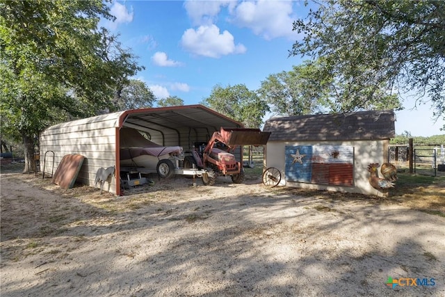1843 Burr Oak Ln, Adkins, TX 78101 - view of outdoor structure with a detached carport and driveway