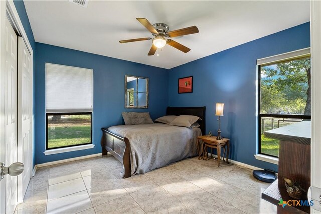 1843 Burr Oak Ln, Adkins, TX 78101 - bedroom with a closet, a ceiling fan, and tile patterned flooring