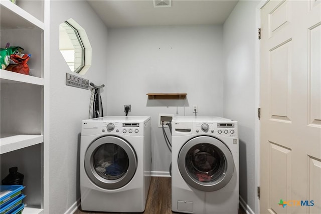 1843 Burr Oak Ln, Adkins, TX 78101 - washroom with washing machine and dryer and wood finished floors