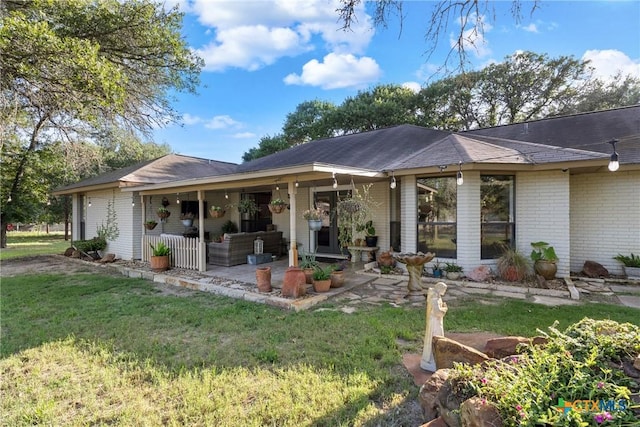 1843 Burr Oak Ln, Adkins, TX 78101 - rear view of house with brick siding, a yard, and a patio area