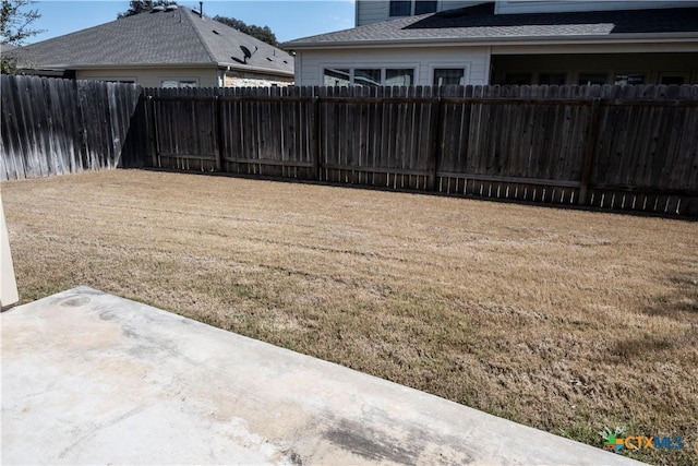 view of yard featuring a patio area and a fenced backyard