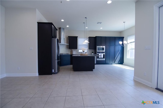 kitchen featuring a center island, baseboards, backsplash, and stainless steel appliances