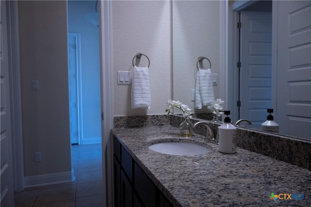 bathroom featuring tile patterned floors, vanity, and baseboards