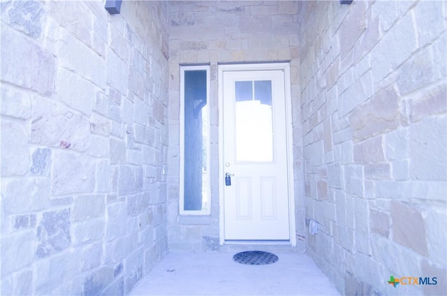 entrance to property featuring stone siding