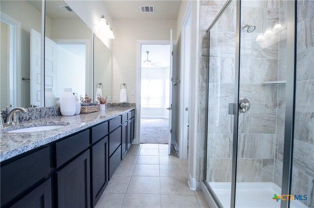 full bath featuring a sink, visible vents, a stall shower, and double vanity