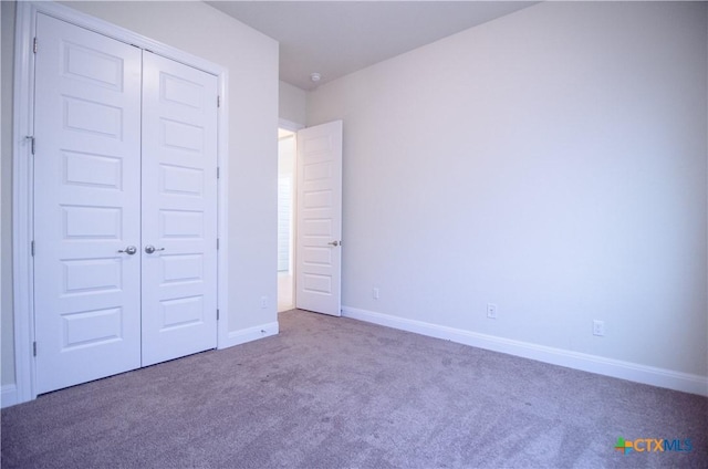 unfurnished bedroom featuring baseboards, a closet, and carpet floors