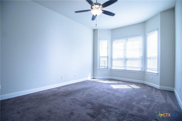 unfurnished room featuring a ceiling fan, carpet, and baseboards