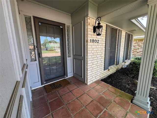 1802 Plantation Rd, Victoria, TX 77904 - doorway to property with brick siding and covered porch