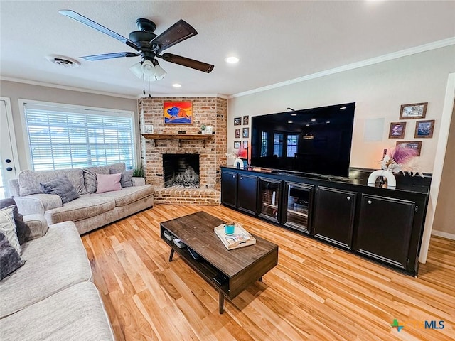 1802 Plantation Rd, Victoria, TX 77904 - living area with crown molding, ceiling fan, light wood-type flooring, a fireplace, and bar area