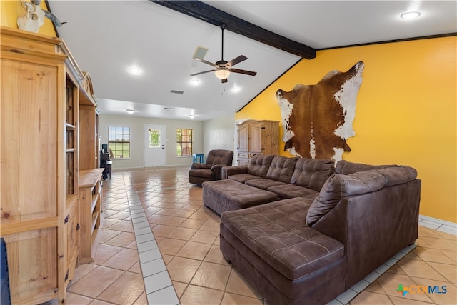 living room with lofted ceiling with beams, light tile patterned floors, and ceiling fan