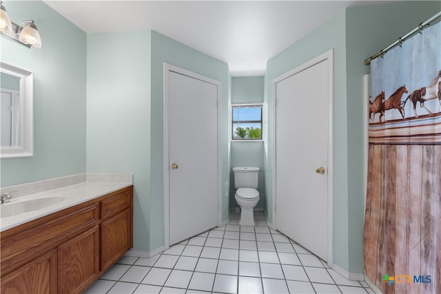 bathroom with vanity, tile patterned floors, and toilet