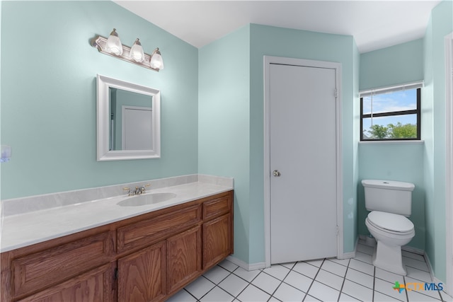 bathroom featuring tile patterned flooring, vanity, and toilet