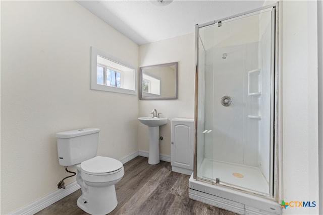 bathroom featuring toilet, an enclosed shower, and hardwood / wood-style flooring