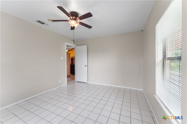 tiled empty room with ceiling fan