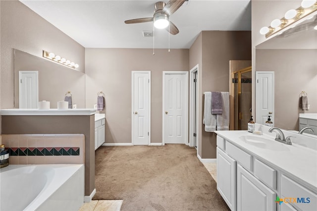 6804 Robert Dixon Dr, Austin, TX 78749 - full bathroom with ceiling fan, a garden tub, a stall shower, baseboards, and vanity