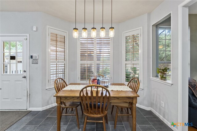6804 Robert Dixon Dr, Austin, TX 78749 - dining room with dark tile patterned floors, healthy amount of natural light, and baseboards