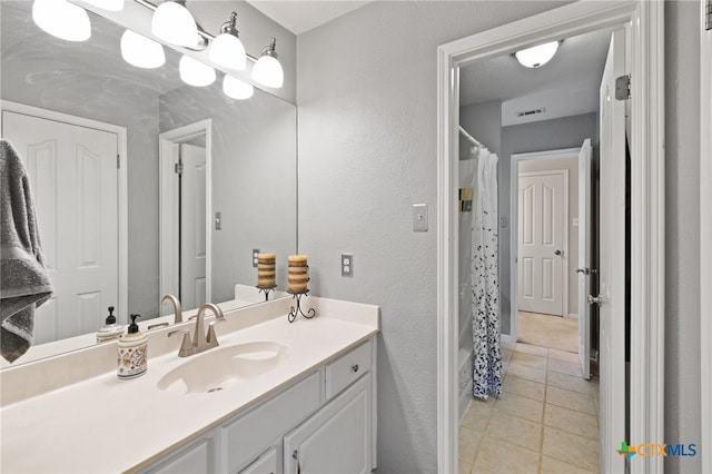 6804 Robert Dixon Dr, Austin, TX 78749 - bathroom featuring tile patterned floors, vanity, and a textured wall