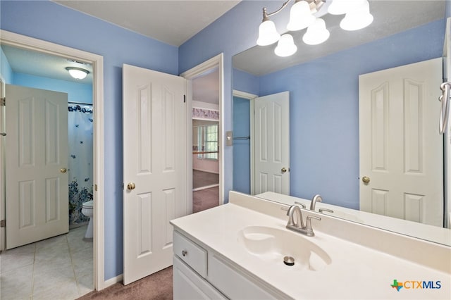 6804 Robert Dixon Dr, Austin, TX 78749 - full bath with toilet, vanity, a chandelier, and baseboards