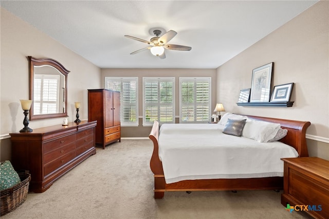 6804 Robert Dixon Dr, Austin, TX 78749 - bedroom featuring multiple windows, light colored carpet, a ceiling fan, and baseboards