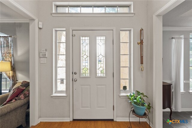 6804 Robert Dixon Dr, Austin, TX 78749 - entryway with baseboards, ornamental molding, and wood finished floors