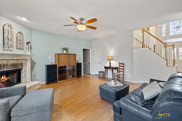 6804 Robert Dixon Dr, Austin, TX 78749 - living room featuring stairway, ceiling fan, light wood-style floors, and a stone fireplace