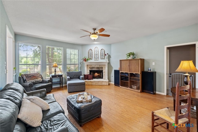 6804 Robert Dixon Dr, Austin, TX 78749 - living area featuring ceiling fan, light wood-style floors, a fireplace, and baseboards