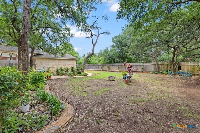 6804 Robert Dixon Dr, Austin, TX 78749 - fenced backyard featuring an outdoor fire pit