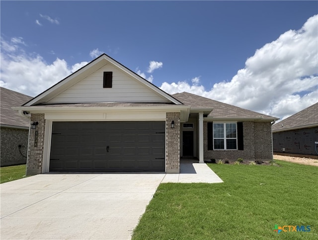 1238 Dowdy Dr, Belton, TX 76513 - ranch-style home featuring concrete driveway, brick siding, a garage, and a front yard