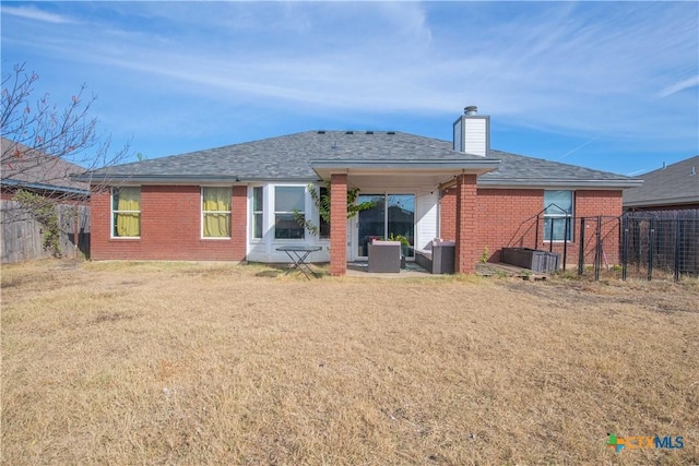 rear view of property featuring a lawn and an outdoor living space