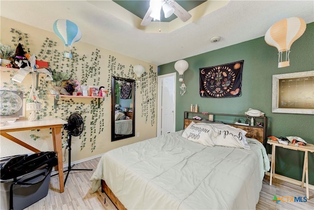 bedroom with ceiling fan and light hardwood / wood-style floors