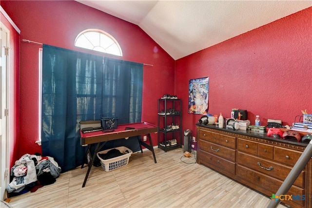 miscellaneous room featuring light hardwood / wood-style floors and lofted ceiling