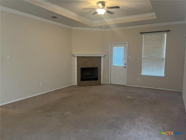 9210 Devonshire Ct, Killeen, TX 76542 - unfurnished living room with a raised ceiling, ornamental molding, ceiling fan, a tiled fireplace, and baseboards