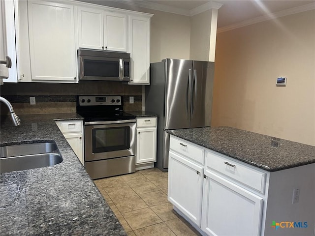 9210 Devonshire Ct, Killeen, TX 76542 - kitchen featuring stainless steel appliances, a sink, ornamental molding, white cabinets, and dark stone countertops