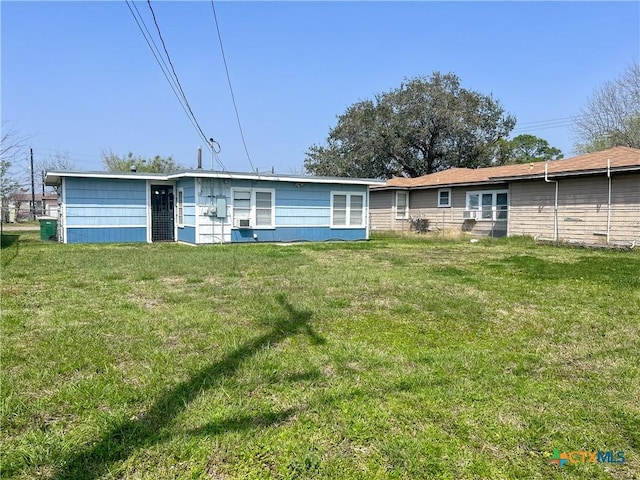 back of house with a yard