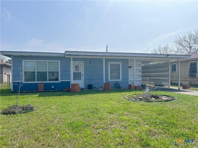 view of front of house with an attached carport and a front lawn