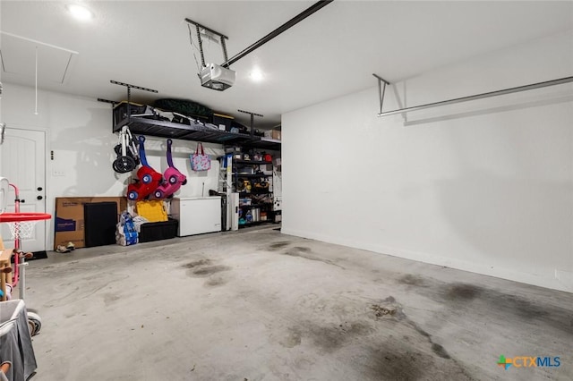 garage with a garage door opener and fridge