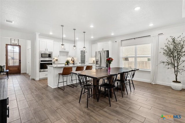 dining space featuring crown molding